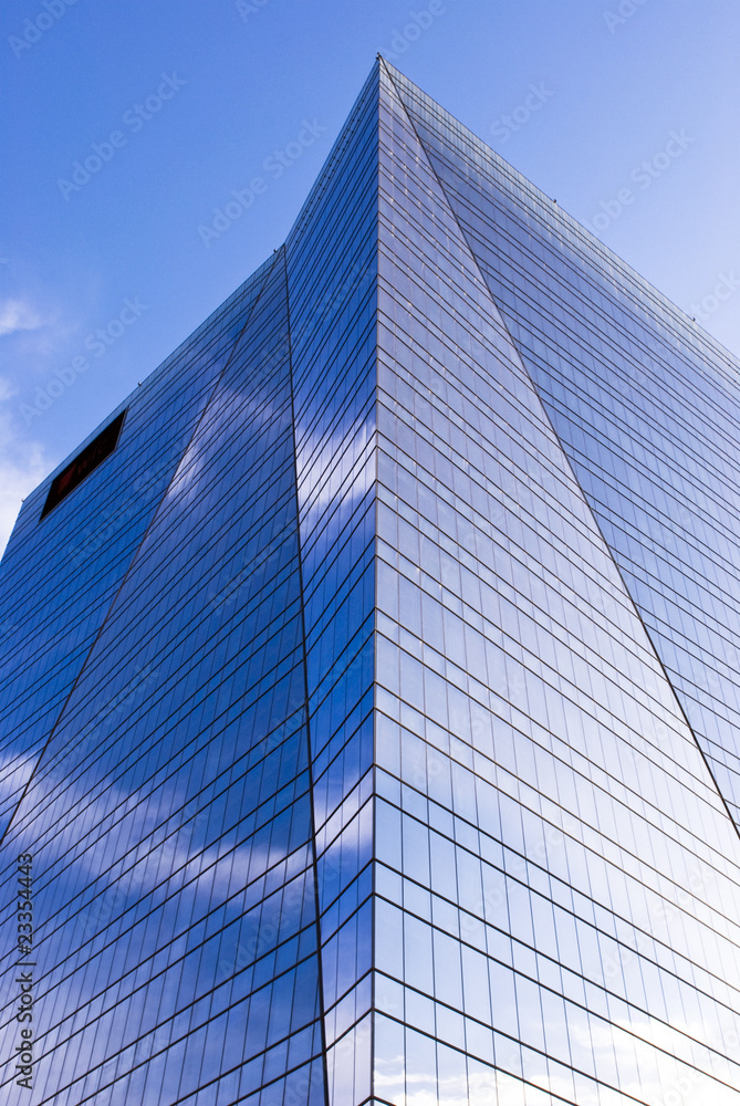 Highrise glass building with sky and clouds reflection Highrise glass building with sky and clouds reflection