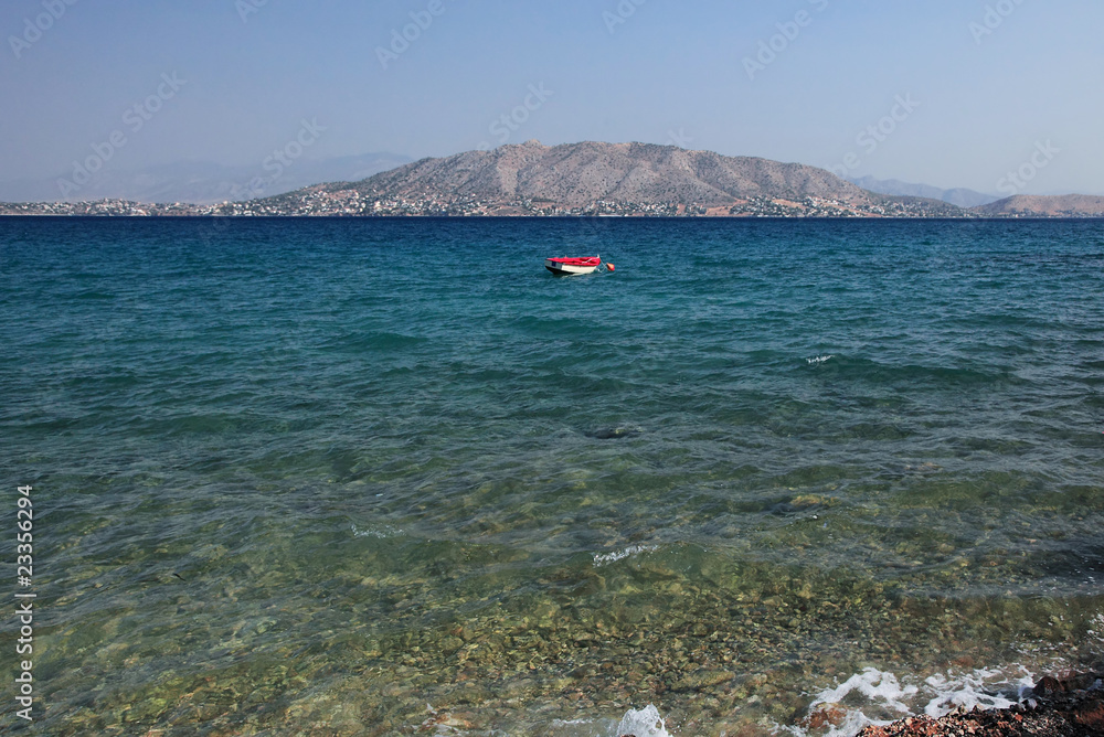 Red boat floating in Greece