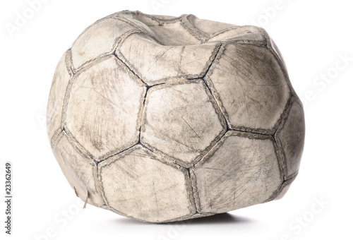 old deflated soccer ball isolated on white