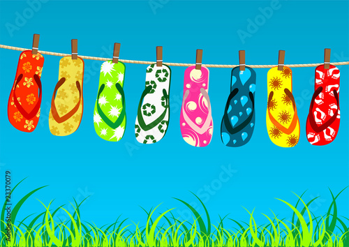 Beach sandals Different colorful flip-flops hanged on a rope