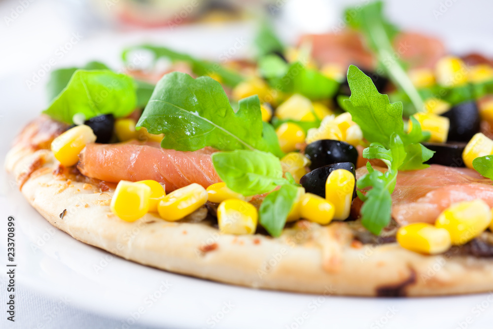 Pizza with salmon and vegetables