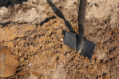 Shovel putted into heap of ground photo