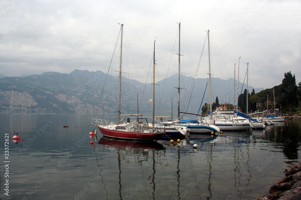 Yachts with down sails on Lago di Garda lake Yachts with down sails on Lago di Garda lake