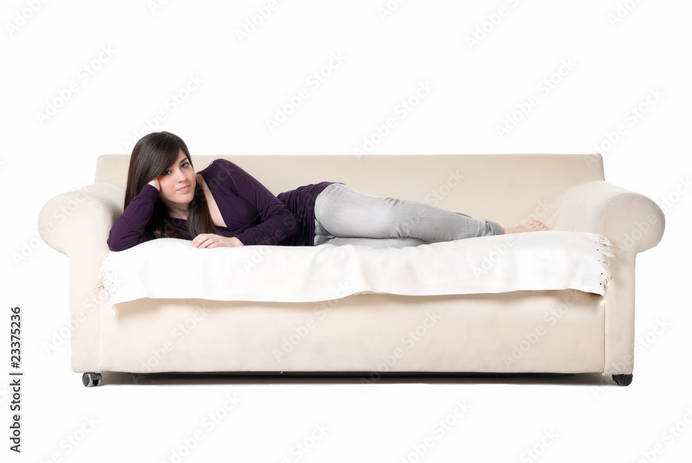 Young beautiful woman lying on sofa isolated on white background Young beautiful woman lying on sofa isolated on white background