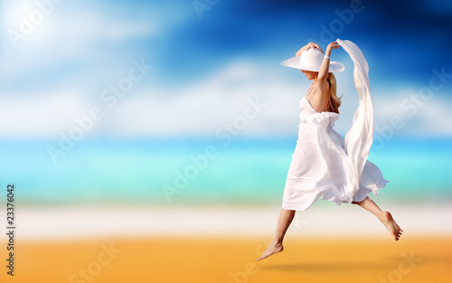 Young beautiful women in the white on the sunny tropical beach photo