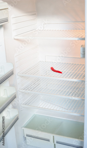 Empty fridge with chili pepper