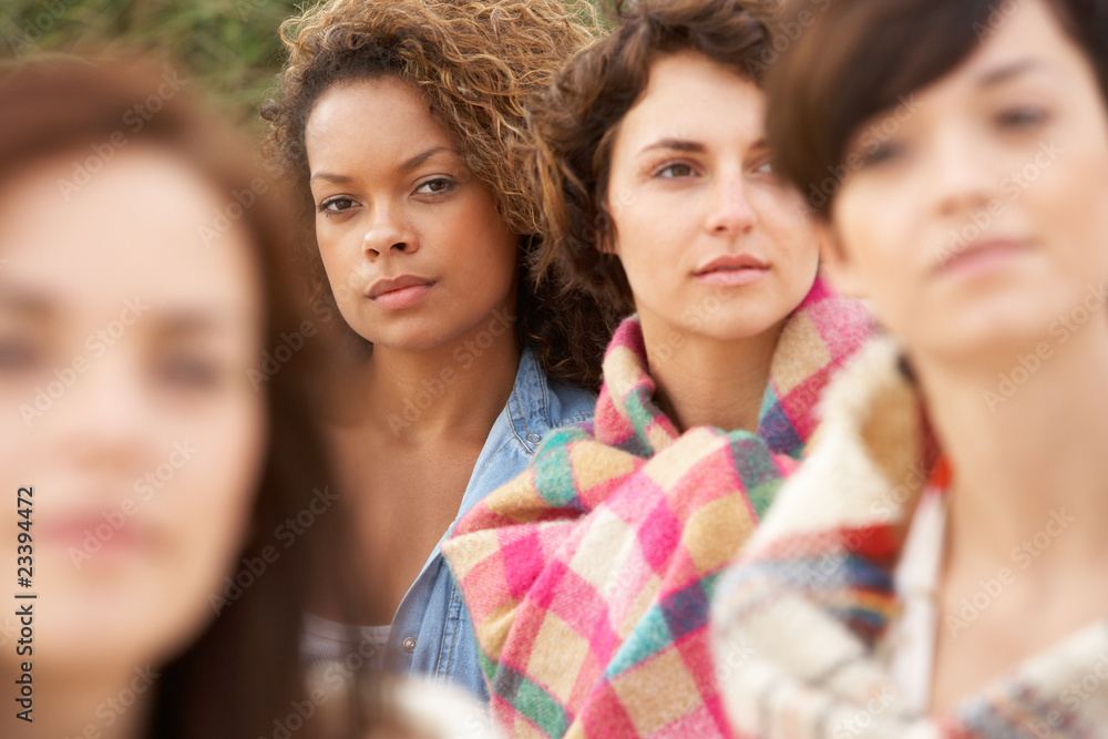 Obraz premium Close Up Of Group Of Girls Sitting On Beach Together