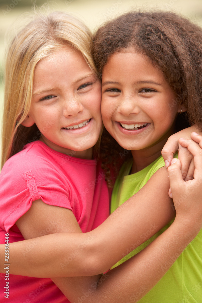 Two Girls In Park Giving Each Other Hug Two Girls In Park Giving Each Other Hug