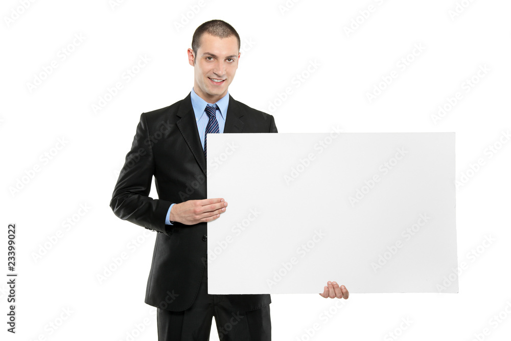 A young businessman holding a white blank card A young businessman holding a white blank card