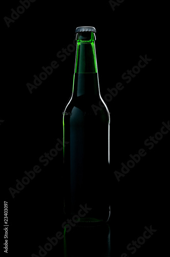 a green bottle beer over black background with shadow