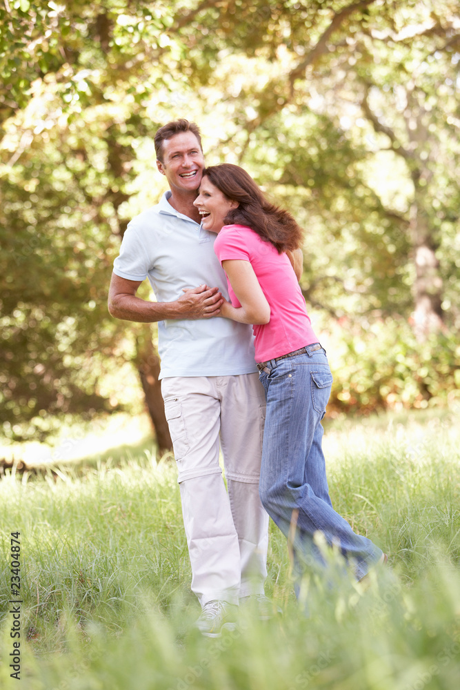 Portrait Of Young Couple Walking In Park Portrait Of Young Couple Walking In Park