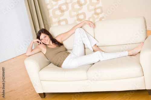 Smiling woman relax on sofa in lounge