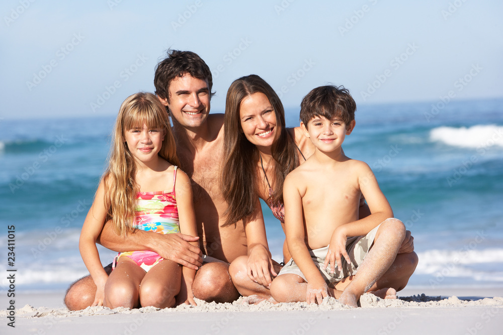 Young Family Relaxing On Beach Holiday Young Family Relaxing On Beach Holiday