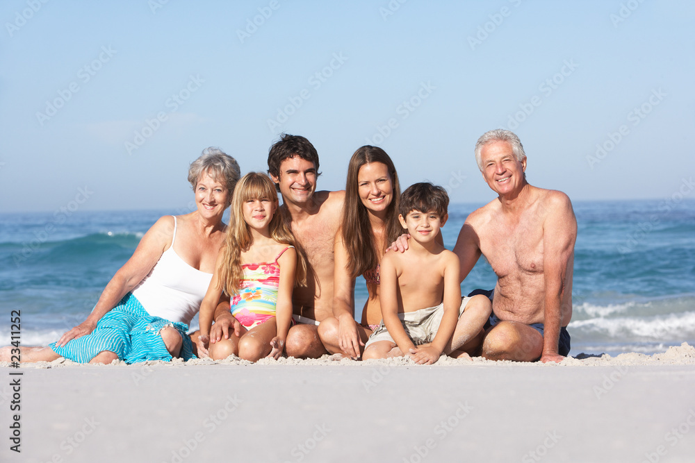 Three Generation Family On Holiday Walking Along Beach Three Generation Family On Holiday Walking Along Beach