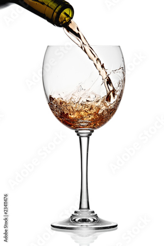 White wine poured in a glass isolated on a white background
