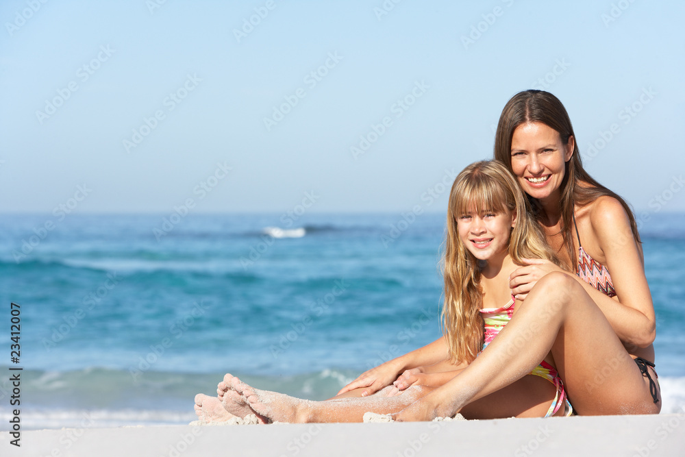 Mother And Daughter Relaxing Together On Beach Holiday Mother And Daughter Relaxing Together On Beach Holiday