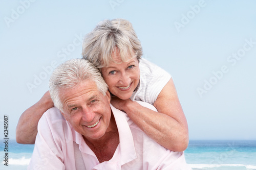 Senior Couple Relaxing On Beach Holiday