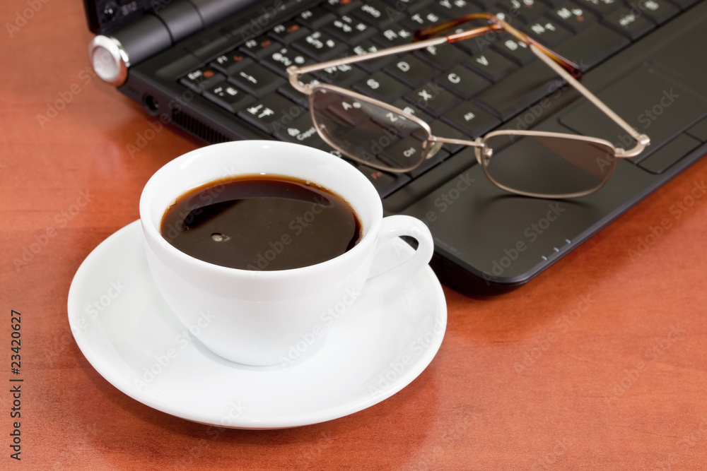 notebook, glasses and cup of coffee