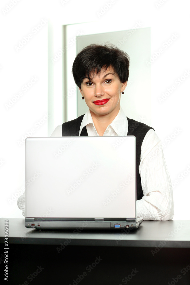 Beautiful smiling woman with a laptop at the table Beautiful smiling woman with a laptop at the table