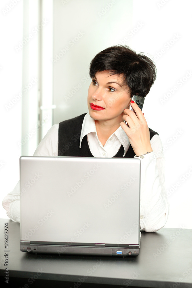 Beautiful woman with a mobile phone and a laptop Beautiful woman with a mobile phone and a laptop