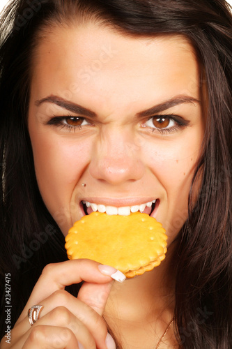 Woman eating cookie with anger