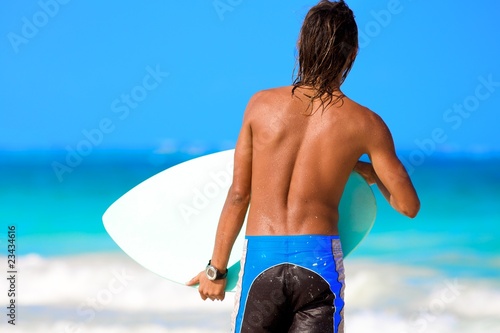 guy with a surfboard on sunny day photo