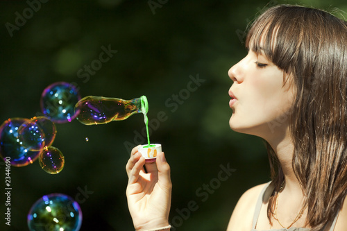 teen blowing bubbles