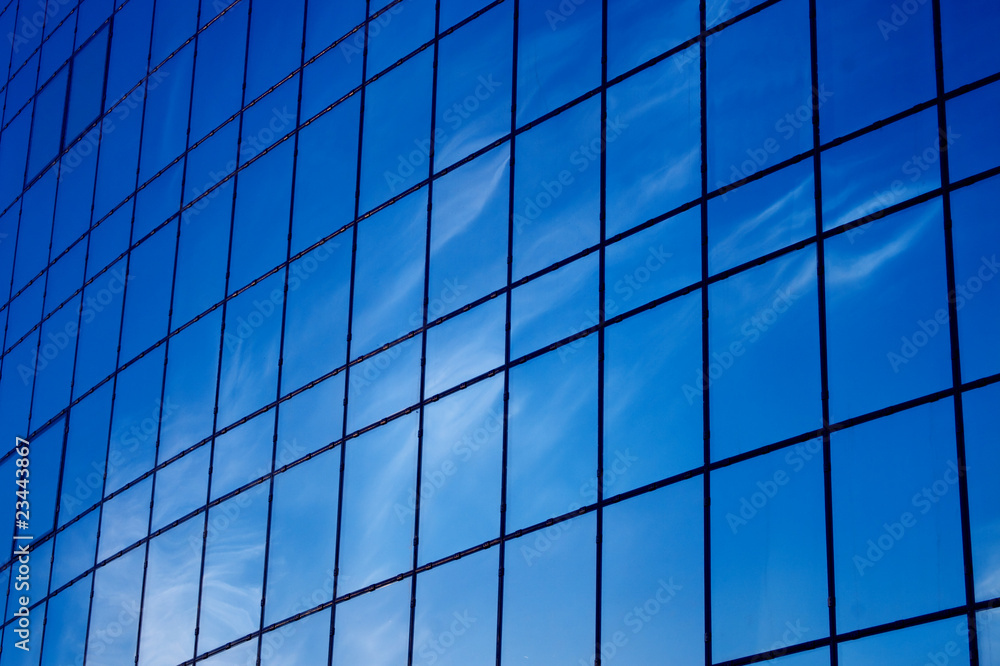 Background. Blue windows and sky reflections. Modern building