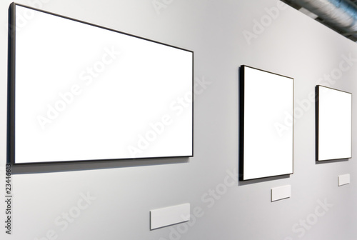 White wall in museum with empty frames photo