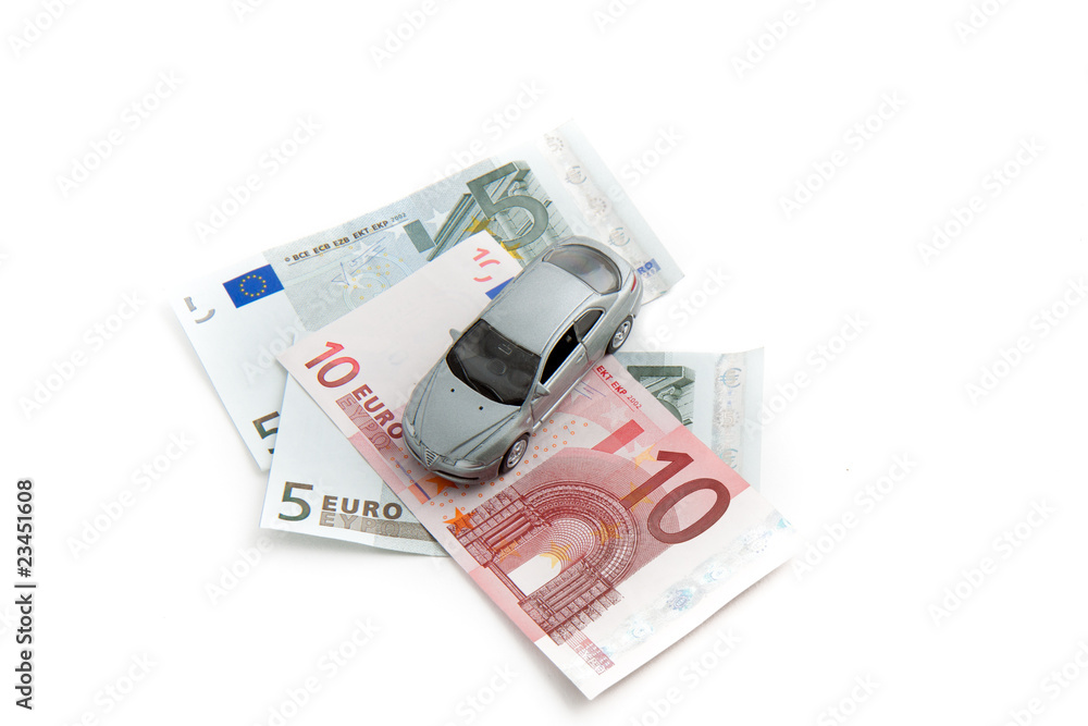 Toy car on money. Isolated on white background Toy car on money. Isolated on white background