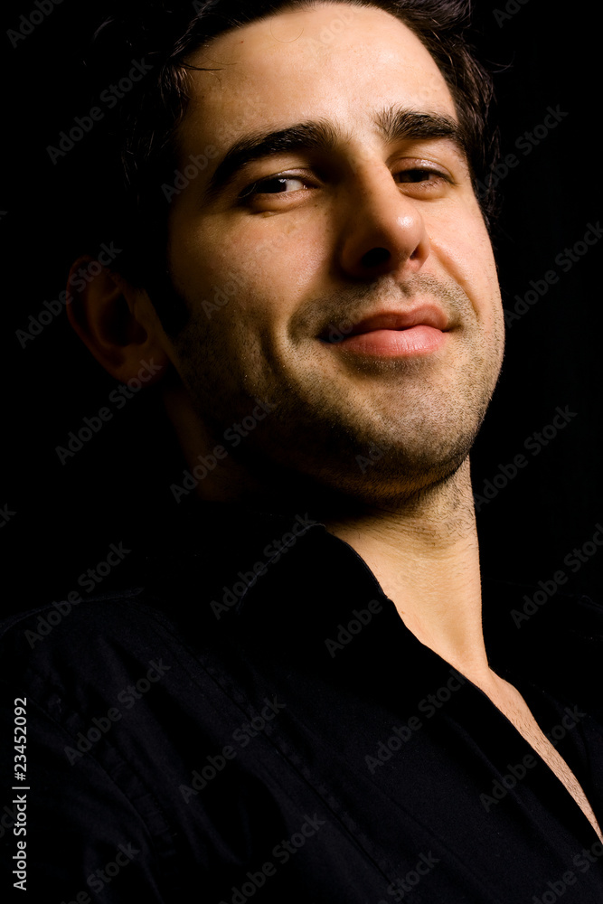 Portrait of young attractive man on a black background Portrait of young attractive man on a black background