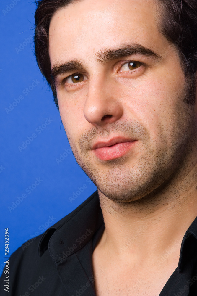 Fototapeta premium Young casual atractive man portrait, on a blue background