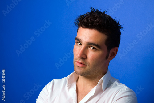 young casual man portrait, on blue background