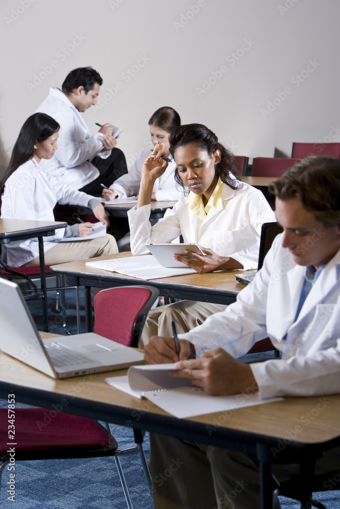Multiracial medical students studying in classroom