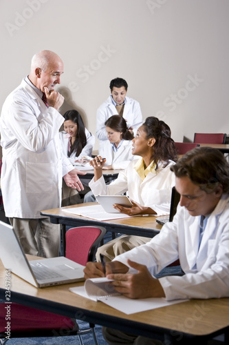 Professor with medical students in classroom