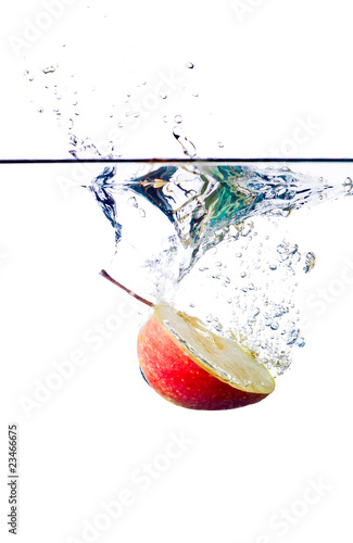 green apple splashing into water isolated on white