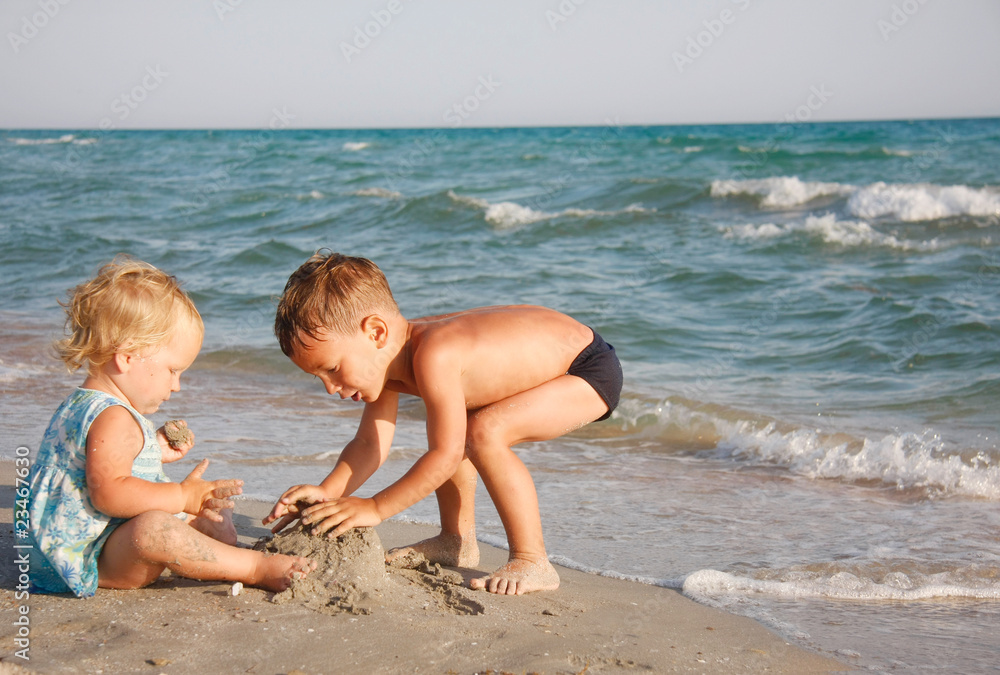 two kids playing on beach
