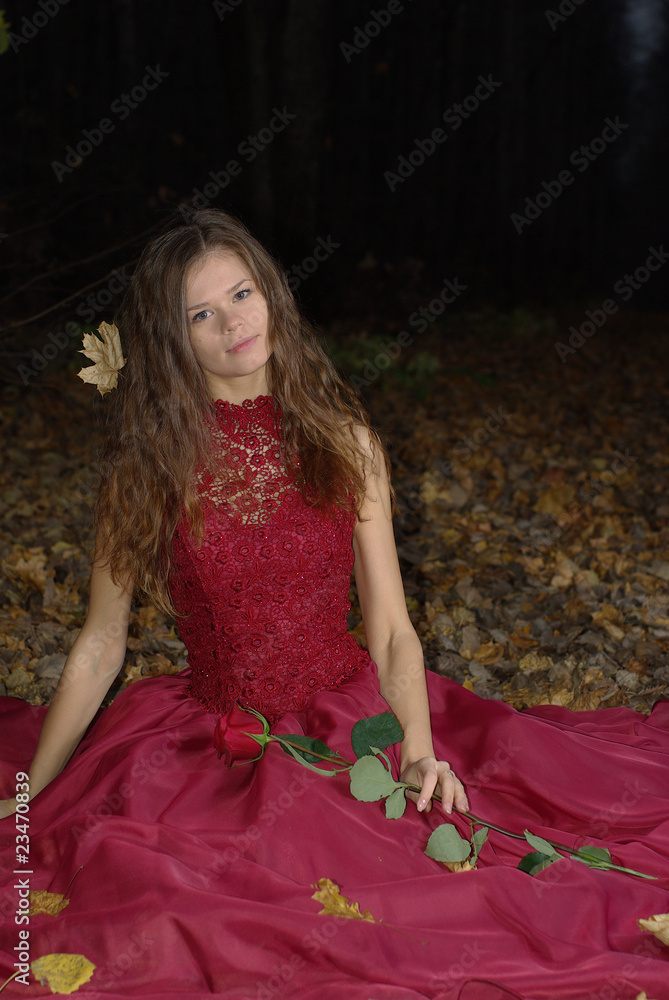 girl in a red dress with a maple leaf in her hair girl in a red dress with a maple leaf in her hair
