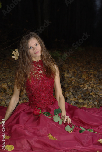 girl in a red dress with a maple leaf in her hair
