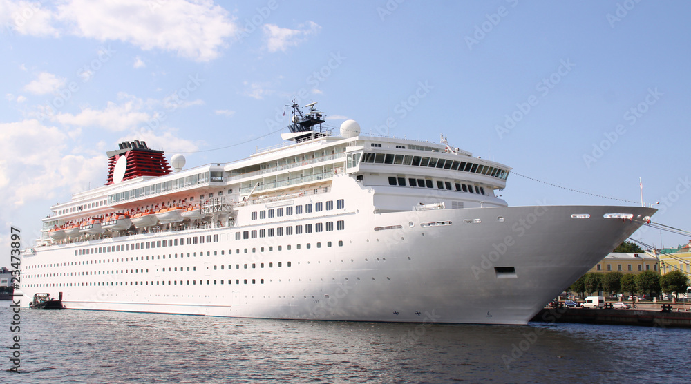 luxury white cruise ship shot at angle at water level