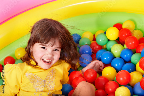 Happy child in group colourful ball. photo