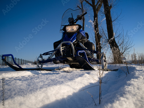 Snowmobile against a blue sky photo