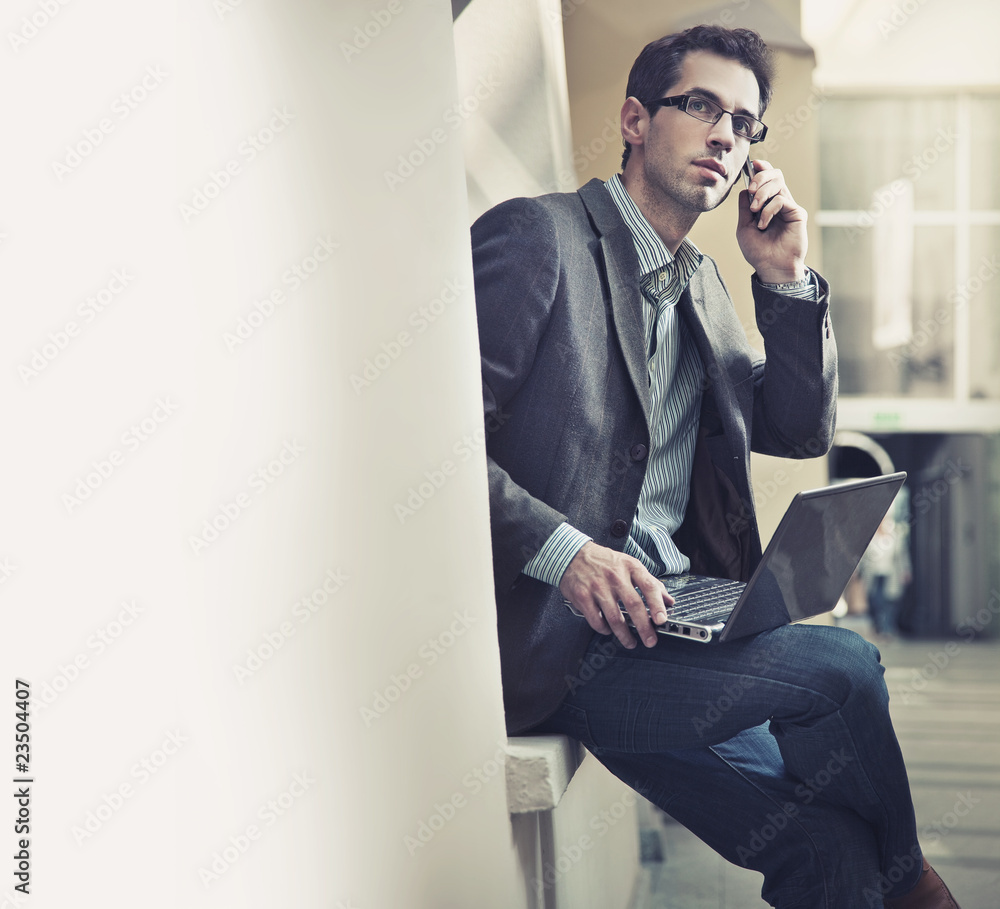 Handsome businessman talking over cellphone Handsome businessman talking over cellphone