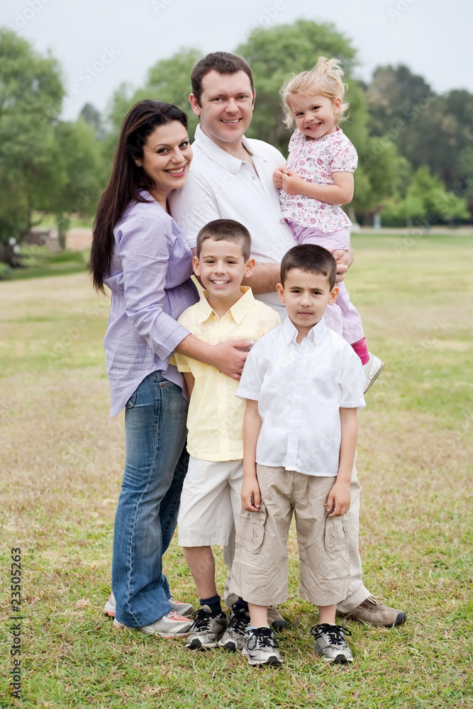 Happy family of five posing on natural background Happy family of five posing on natural background