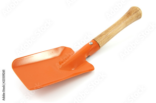 Garden tool; orange shovel over white background