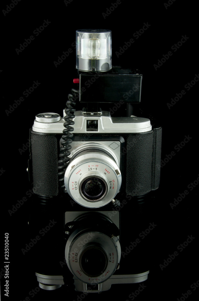 old fashioned photocamera over black background