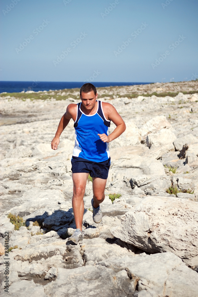 Man running along rocks