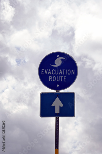 Evacuation Route Sign in Florida against storm clouds