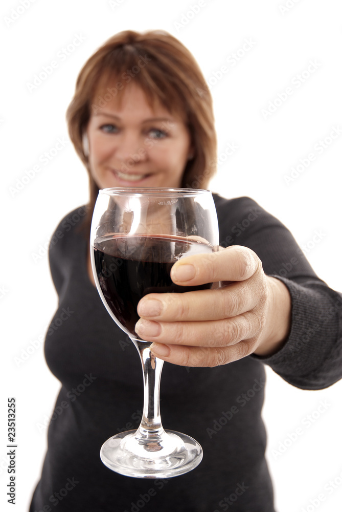 Woman holding out glass of red wine Woman holding out glass of red wine