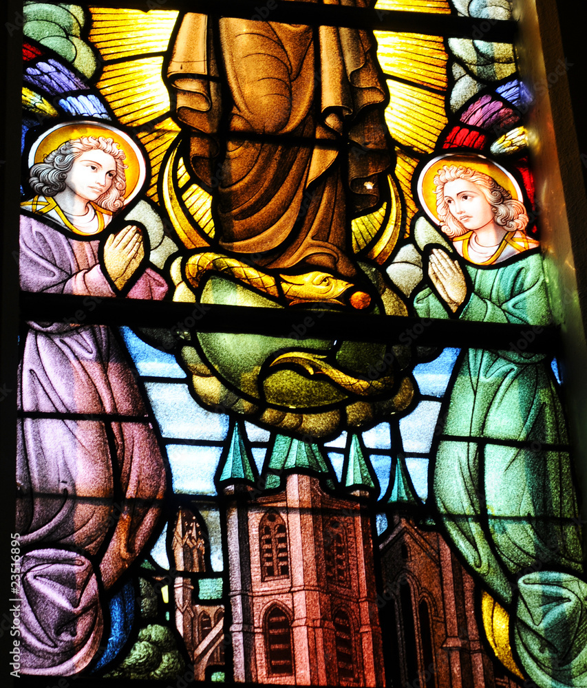 Church window in burning glass, praying angels